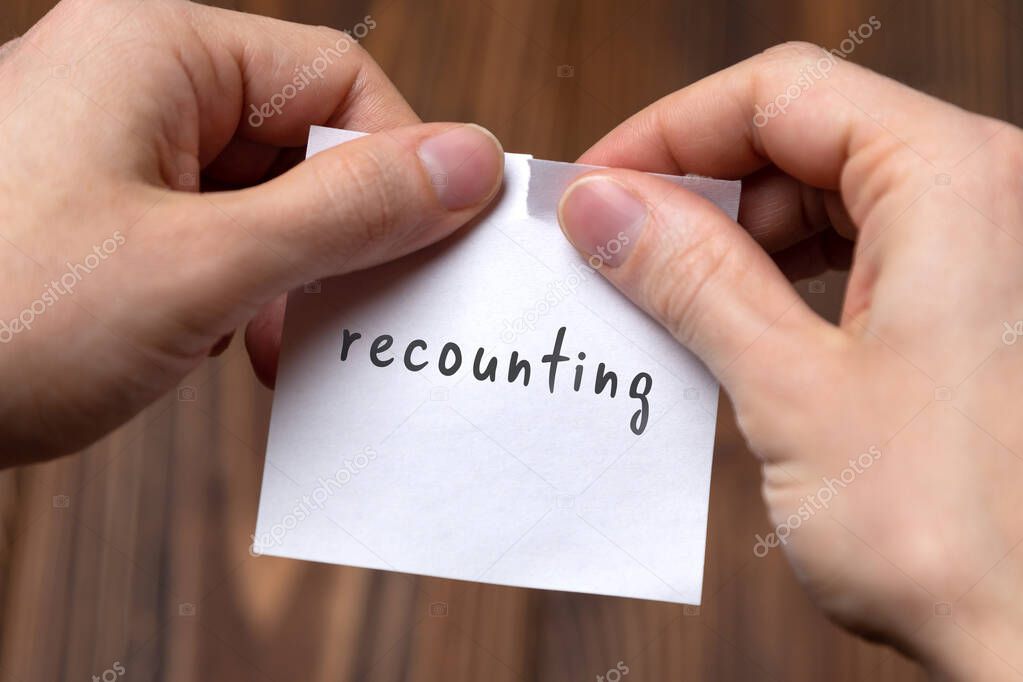 Concept of cancelling. Hands closeup tearing a sheet of paper with inscription recounting