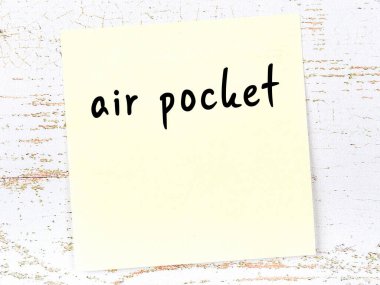 Tahta duvardaki sarı yapışkan notta el yazısıyla yazılmış hava boşluğu var.