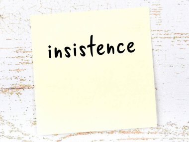 Tahta duvardaki sarı yapışkan notta el yazısıyla yazılmış ısrar var.