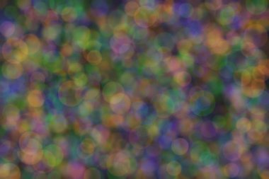 yeşil, turuncu ve mavi soyut çözünmüş arka plan daire şeklindeki bokeh noktalarıyla