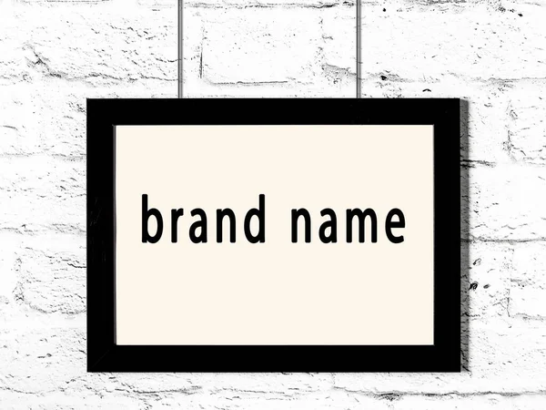 Black Wooden Frame Inscription Brand Name Hanging White Brick Wall — Stock Photo, Image