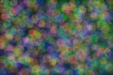 Üç rengin soyut arkaplanı: yeşil, turuncu ve mavi ve bunların karışımı. Bokeh