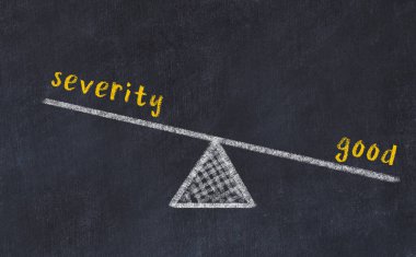 Şiddetle iyilik arasındaki denge. Kara tahtaya yazı tahtası çizimi