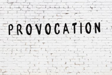 Beyaz tuğla duvara siyah boya ile yazılmış bir yazıt provokasyonu.