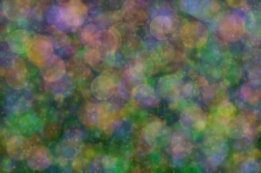 yeşil, turuncu ve mavi soyut çözünmüş arka plan daire şeklindeki bokeh noktalarıyla