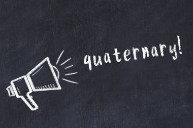 Hoparlörün tebeşir çizimi ve siyah masanın üzerine el yazısıyla yazılmış yazması.