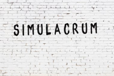 Yazılı beyaz tuğla duvar simülasyonu el yazısıyla siyah boyayla yazılmış.