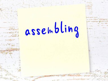 Montajla ilgili hatırlatma kavramı. Tahta duvarda üzerinde yazı olan sarı yapışkan kağıt.