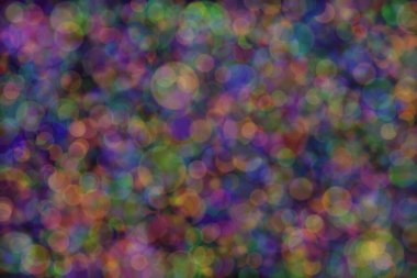 yeşil, turuncu ve mavi soyut çözünmüş arka plan daire şeklindeki bokeh noktalarıyla