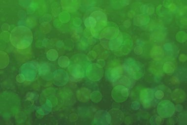 Çember şekilli bokeh benekli yeşil soyut odaklanmış arkaplan