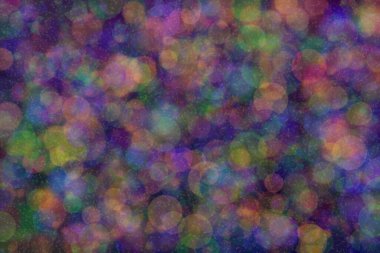 Üç rengin soyut arkaplanı: yeşil, turuncu ve mavi ve bunların karışımı. Bokeh