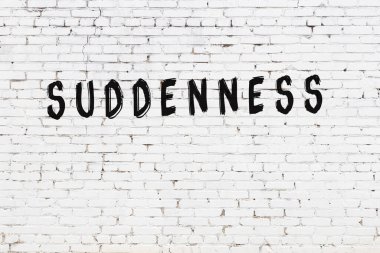 Yazı aniden beyaz tuğla duvara siyah boya ile yazılmış..