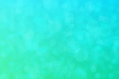 Çember şeklindeki bokeh noktalarıyla mavi ve yeşil soyut odaklanmış arkaplan