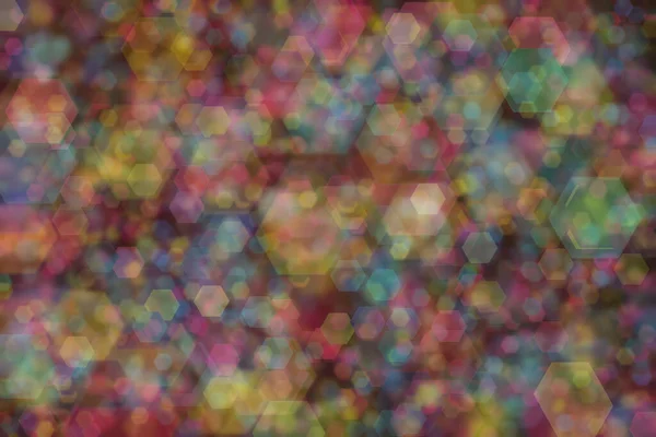 blue, pink and yellow abstract defocused background with hexagon shape bokeh spots