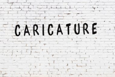 Siyah boyalı el yazısıyla yazılmış beyaz tuğlalı bir duvar.