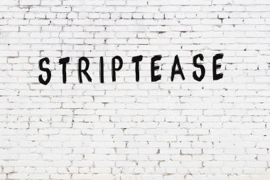 Beyaz tuğlalı duvara siyah boya ile yazılmış yazı şeridi.