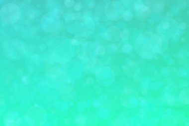 Çember şeklindeki bokeh noktalarıyla mavi ve yeşil soyut odaklanmış arkaplan