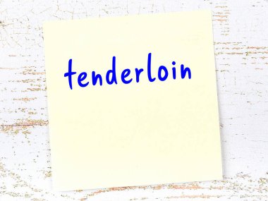 Tahta duvardaki sarı yapışkan notta el yazısıyla yazılmış fileto.