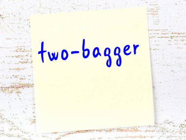 Çift poşetçiyi hatırlatma anlayışı. Tahta duvarda üzerinde yazı olan sarı yapışkan kağıt.