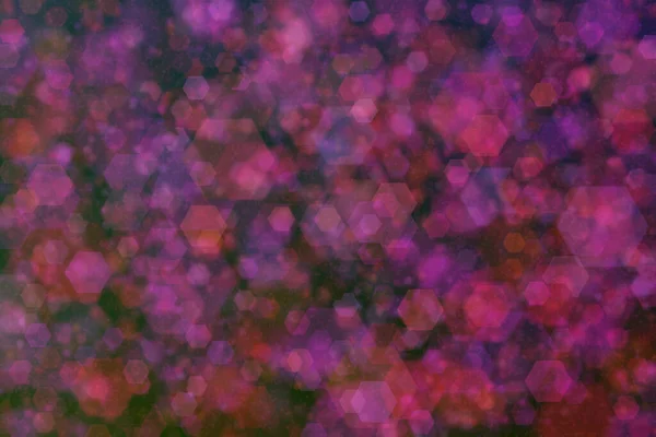 hexagon shaped bokeh with purple and red colors on black background.