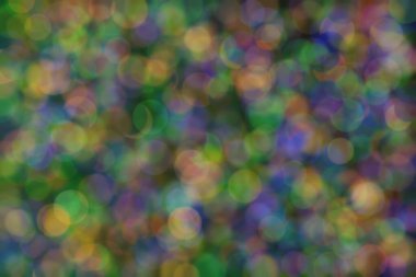 yeşil, turuncu ve mavi soyut çözünmüş arka plan daire şeklindeki bokeh noktalarıyla