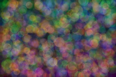 yeşil, turuncu ve mavi soyut çözünmüş arka plan daire şeklindeki bokeh noktalarıyla