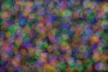 Üç rengin soyut arkaplanı: yeşil, turuncu ve mavi ve bunların karışımı. Bokeh