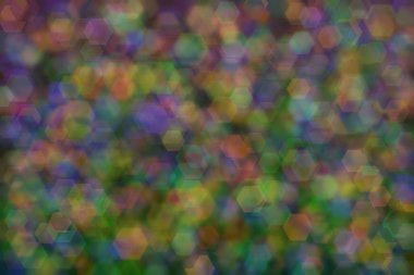 yeşil, turuncu ve mavi soyut çözünmüş arkaplan altıgen şekilli bokeh benekleri