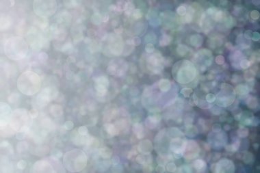Daire şeklinde bokeh noktaları olan renkli bir arkaplan. Soyutlama