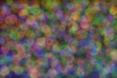 yeşil, turuncu ve mavi soyut çözünmüş arka plan daire şeklindeki bokeh noktalarıyla