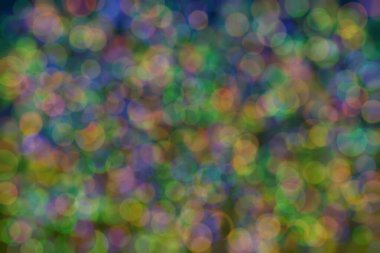 yeşil, turuncu ve mavi soyut çözünmüş arka plan daire şeklindeki bokeh noktalarıyla