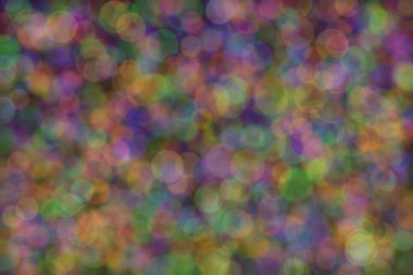 Üç rengin soyut arkaplanı: yeşil, turuncu ve mavi ve bunların karışımı. Bokeh