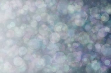 Daire şeklinde bokeh noktaları olan renkli bir arkaplan. Soyutlama