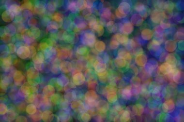 yeşil, turuncu ve mavi soyut çözünmüş arka plan daire şeklindeki bokeh noktalarıyla