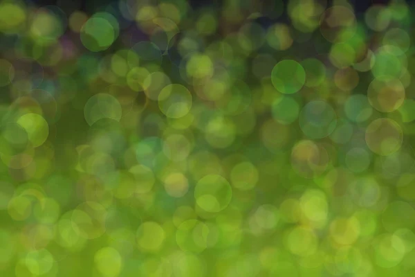 Abstract green background with gradient transitions and light spots. Soft bokeh