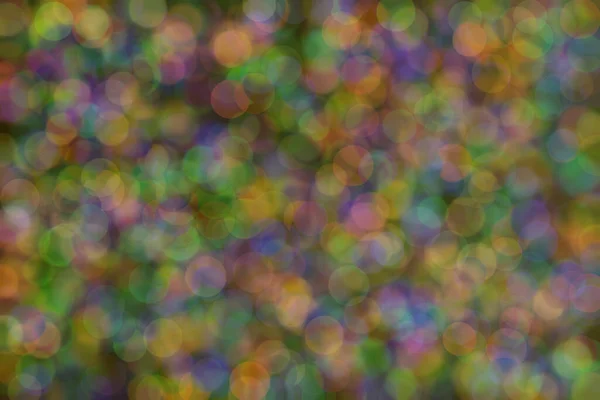 Abstract background of three colors: green, orange and blue and their mixture. Bokeh