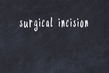 College chalkboard  with with handwritten inscription surgical incision on it