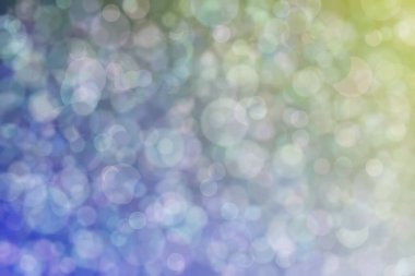 Daire şeklinde bokeh noktaları olan renkli bir arkaplan. Soyutlama