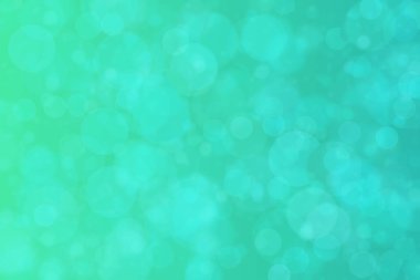 Çember şeklindeki bokeh noktalarıyla mavi ve yeşil soyut odaklanmış arkaplan