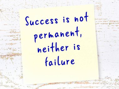 Sarı yapışkan not, ahşap duvarda el yazısıyla yazılmış zekice bir alıntıyla.