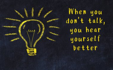 Bir karatahtaya ve bir ampul çizimine elle yazılmış akıllı bir alıntı.