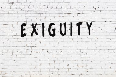 Beyaz tuğla duvara siyah boya ile yazılmış bir yazı..