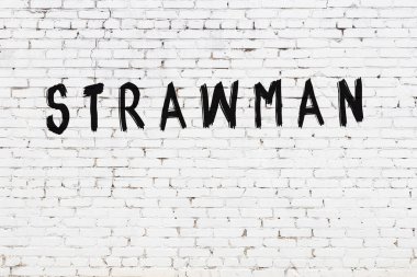 Beyaz tuğla duvara siyah boyayla yazılmış bir kamış adam..