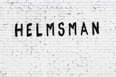 Yazıt dümencisi beyaz tuğla duvara siyah boya ile yazılmış..