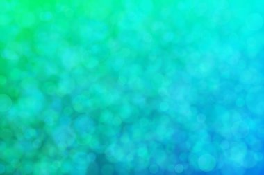 Yeşil ve mavi soyut arkaplan, yeşilden maviye ve daire şeklindeki beneklere geçiş.