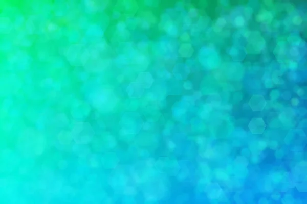 六角形のボケスポットを持つ緑と青の抽象的背景 — ストック写真