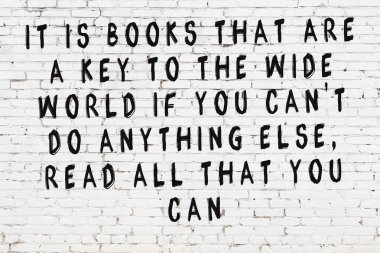 Üzerinde mantıklı alıntıların yazılı olduğu siyah boyanmış beyaz tuğla duvar.