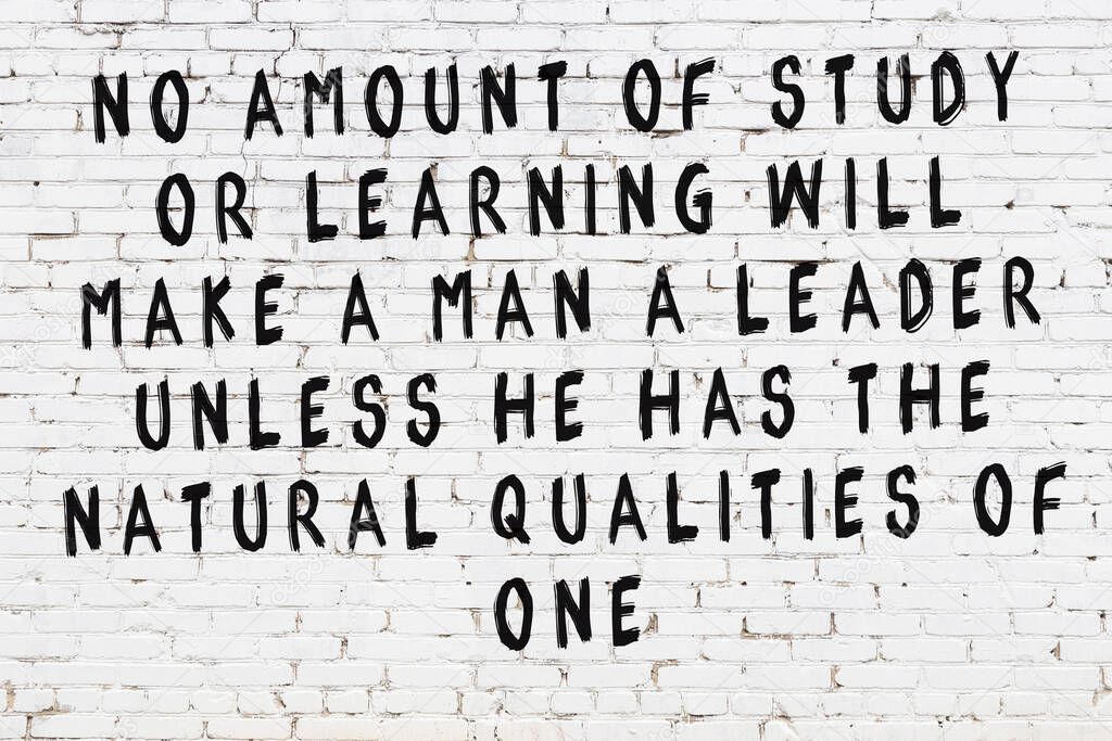 White brick wall and  black painted inscription of  wise quotation