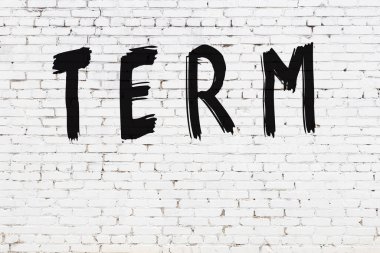 Beyaz tuğla duvara siyah boya ile yazılmış yazı terimi.