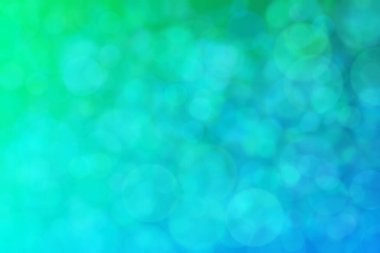 Yeşil ve mavi soyut arkaplan, yeşilden maviye ve daire şeklindeki beneklere geçiş.